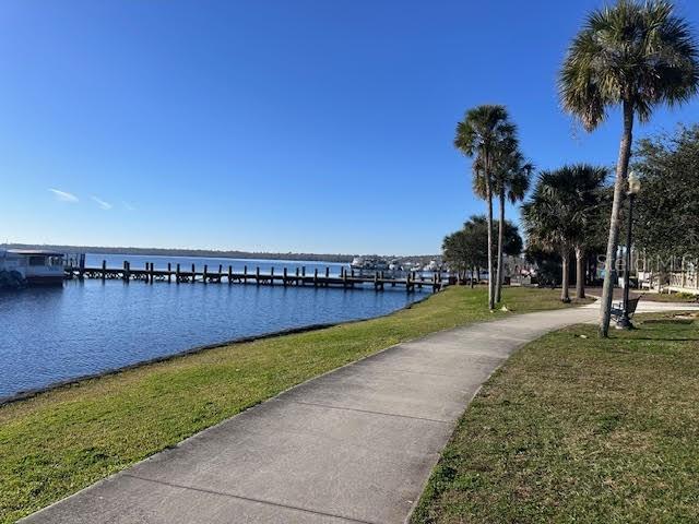 exterior space with a water view and a lawn