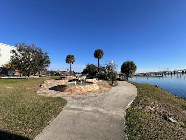 view of community with a yard and a water view