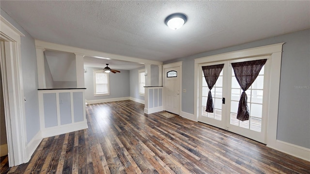 foyer featuring a textured ceiling, dark hardwood / wood-style flooring, and ceiling fan