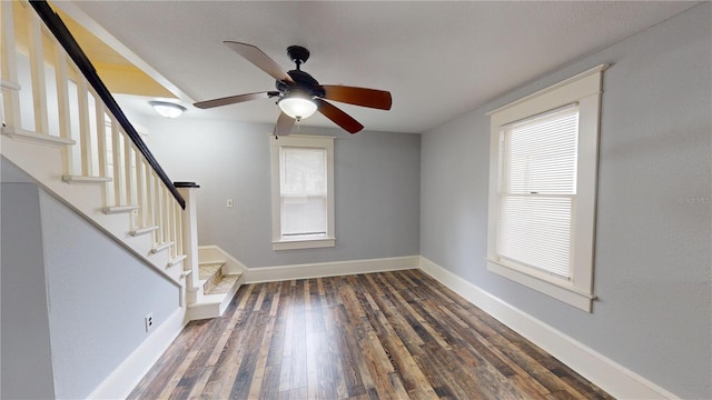 interior space featuring ceiling fan and dark wood-type flooring