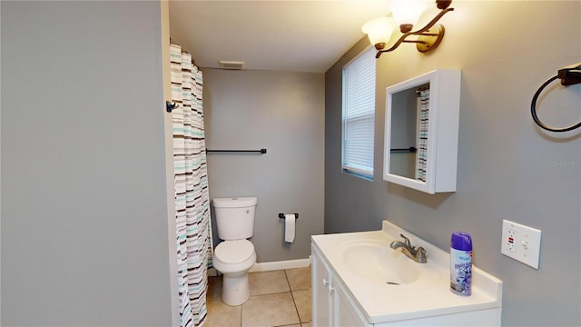 bathroom featuring tile patterned floors, vanity, toilet, and a notable chandelier