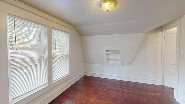 unfurnished room featuring dark hardwood / wood-style flooring and vaulted ceiling