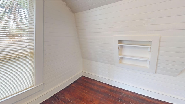 spare room with hardwood / wood-style floors and lofted ceiling