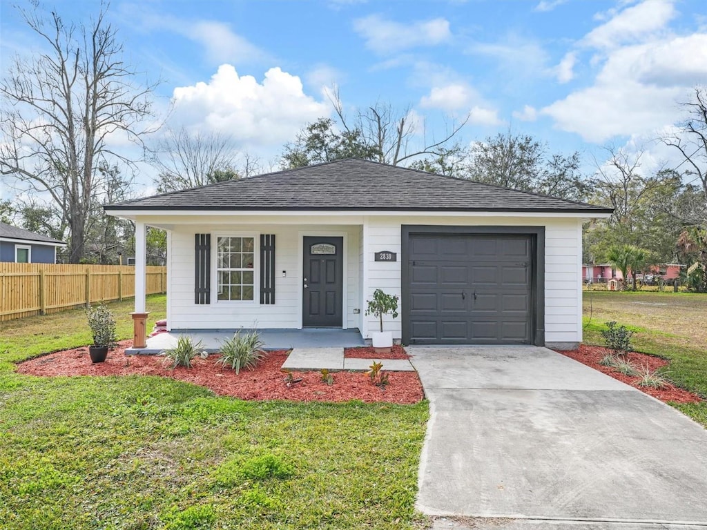 view of front of house with a porch, a garage, and a front yard