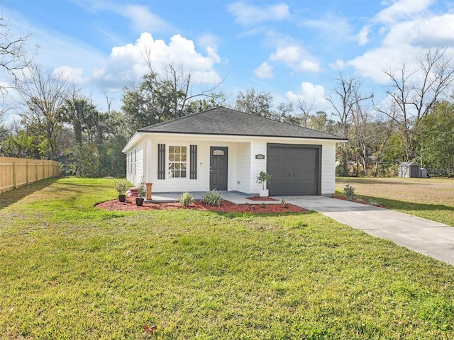 ranch-style house featuring a garage, covered porch, and a front yard