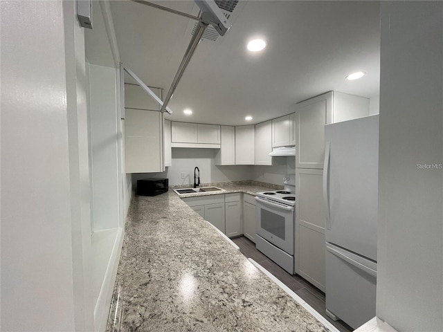 kitchen featuring sink, fridge, white cabinets, light stone counters, and white electric range oven