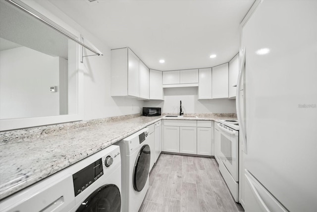 kitchen with white appliances, white cabinets, washer / dryer, and sink