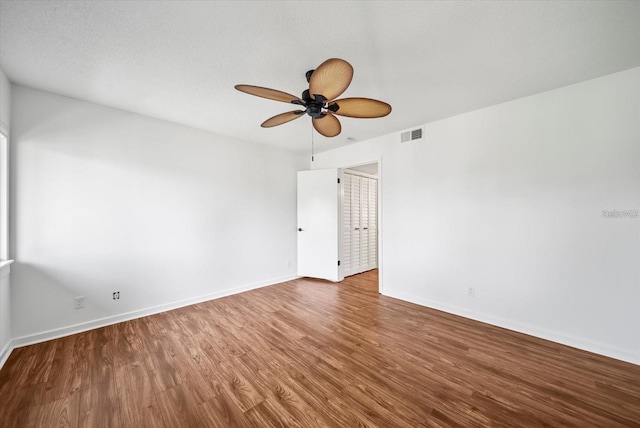 spare room with ceiling fan and hardwood / wood-style floors