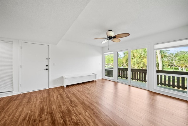 unfurnished sunroom featuring ceiling fan