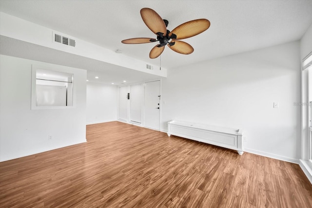 empty room featuring light wood-type flooring and ceiling fan