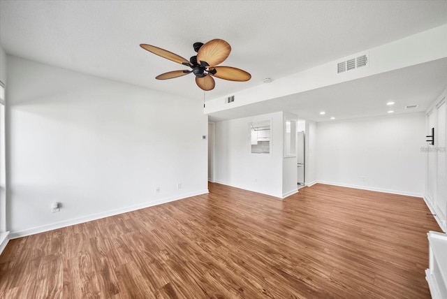 unfurnished living room with ceiling fan and hardwood / wood-style flooring