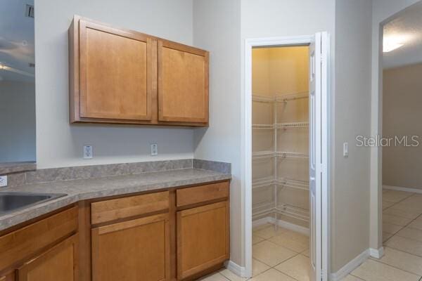 kitchen with light tile patterned flooring and sink