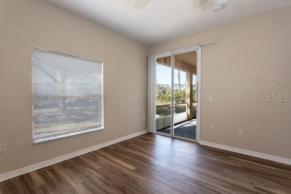 spare room featuring dark hardwood / wood-style floors and ceiling fan