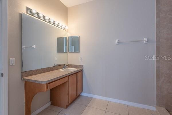 bathroom featuring tile patterned flooring and vanity