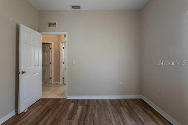 empty room with wood-type flooring