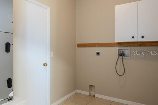 washroom with cabinets, washer hookup, light tile patterned floors, and electric dryer hookup