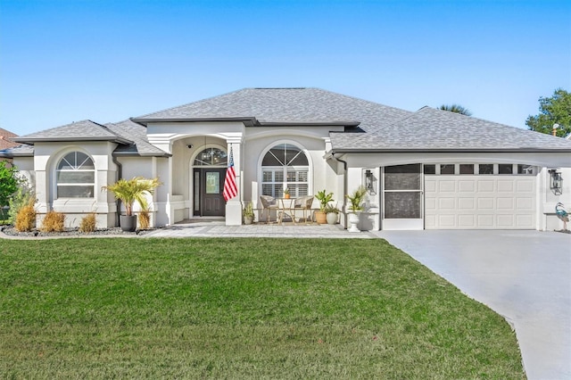 view of front of property featuring a garage and a front lawn