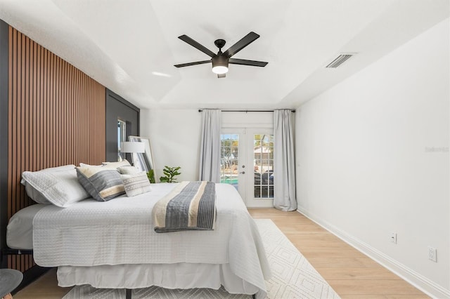 bedroom featuring hardwood / wood-style flooring, ceiling fan, access to outside, and french doors