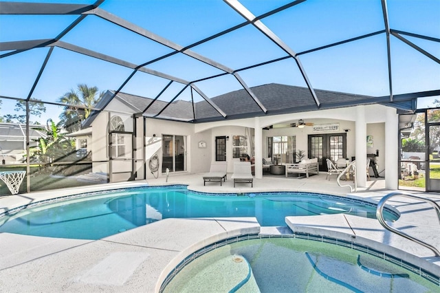 view of swimming pool with outdoor lounge area, glass enclosure, ceiling fan, and a patio area