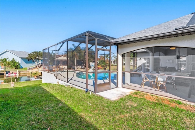 view of pool with a patio area, a lanai, and a lawn