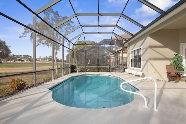 view of pool featuring a patio and glass enclosure