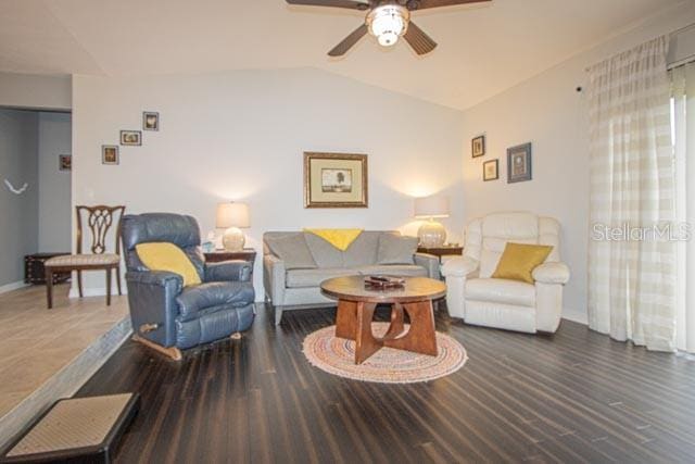 living room featuring dark wood-type flooring, ceiling fan, and lofted ceiling