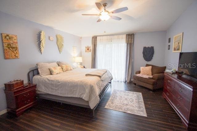 bedroom featuring ceiling fan and dark wood-type flooring