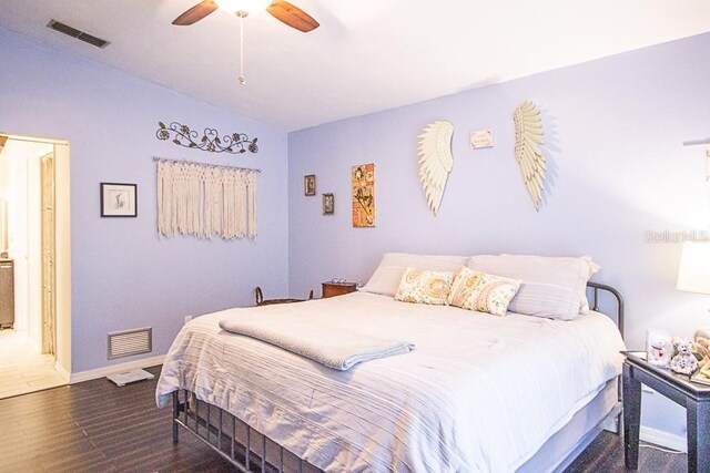 bedroom with ceiling fan, dark hardwood / wood-style flooring, and vaulted ceiling