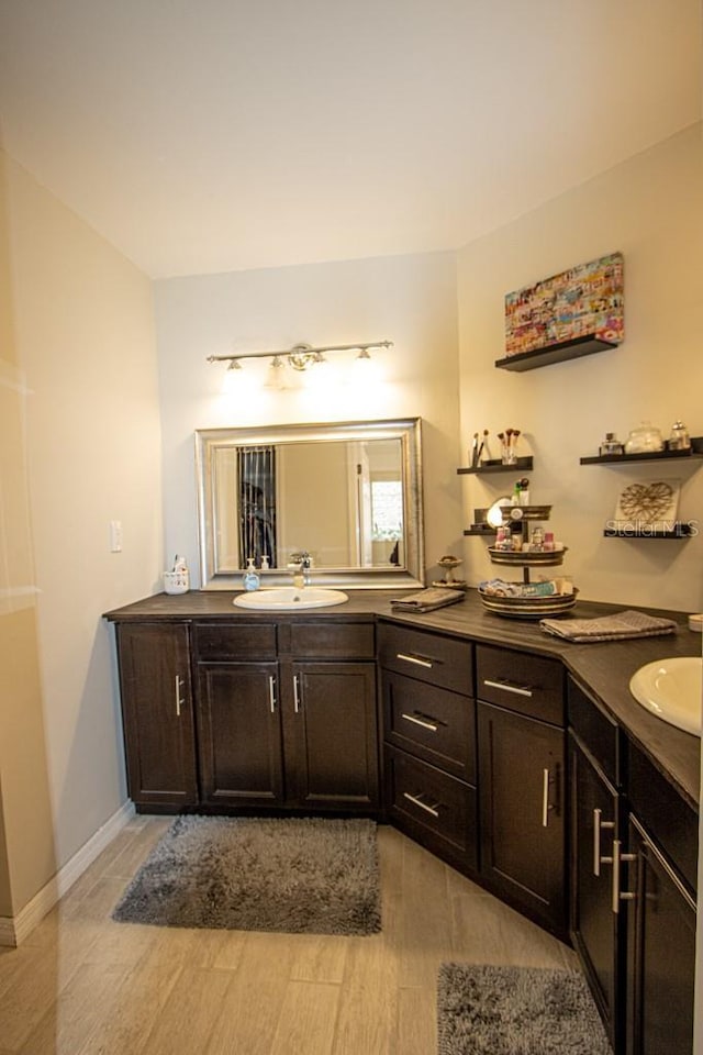 bathroom with hardwood / wood-style floors and vanity