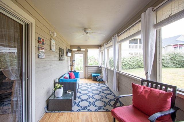 sunroom / solarium featuring ceiling fan