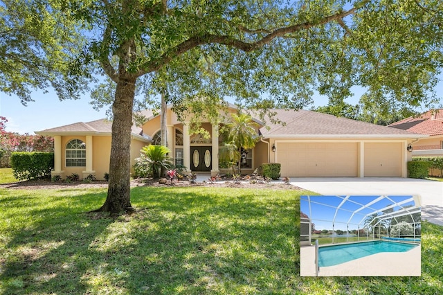 view of front of home featuring a garage, a front lawn, and stucco siding