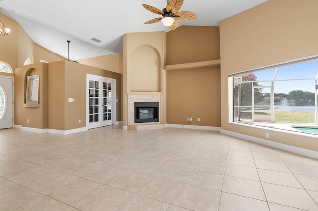 unfurnished living room with a tile fireplace, visible vents, baseboards, and light tile patterned floors