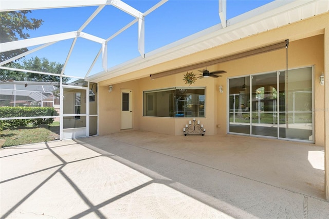 view of patio / terrace featuring glass enclosure and a ceiling fan