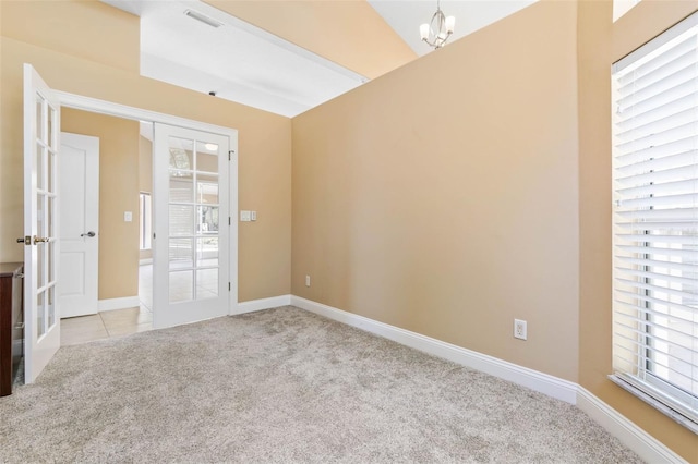 unfurnished room featuring light carpet, french doors, visible vents, and baseboards