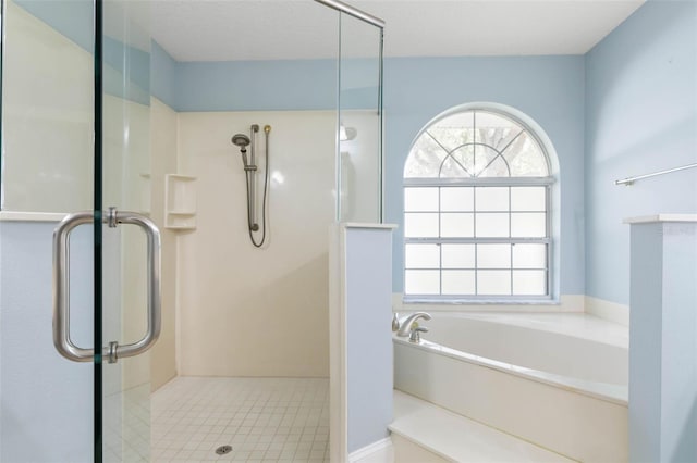 full bathroom featuring a garden tub and a shower with shower door