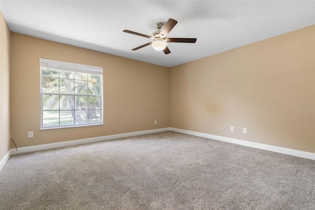 spare room featuring a ceiling fan, carpet flooring, a textured ceiling, and baseboards