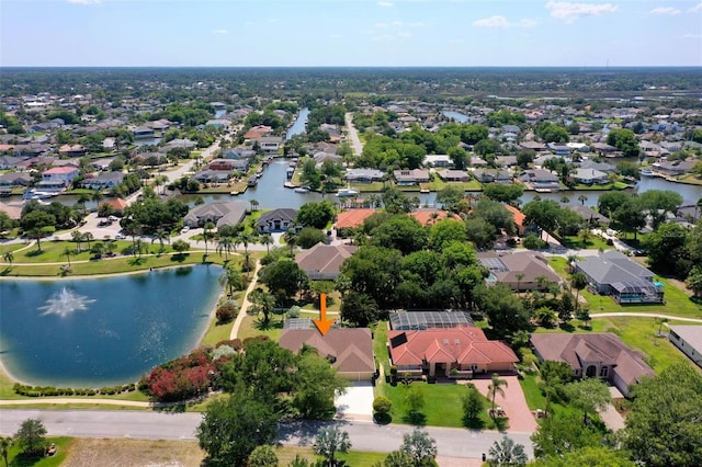 drone / aerial view with a water view and a residential view