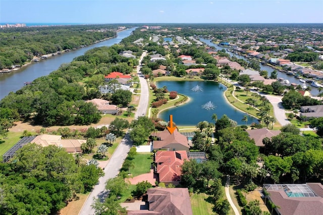 birds eye view of property with a water view and a residential view