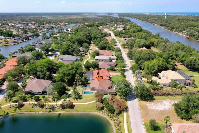 drone / aerial view featuring a water view and a residential view