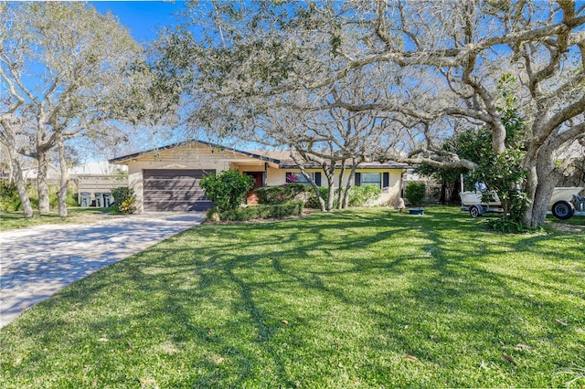 ranch-style home featuring a garage and a front lawn