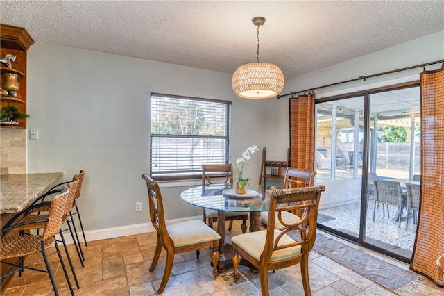 dining space with a textured ceiling