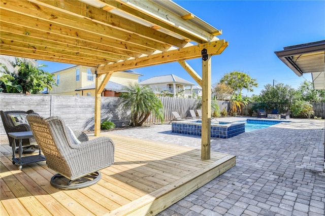 deck featuring a patio and a pool with hot tub