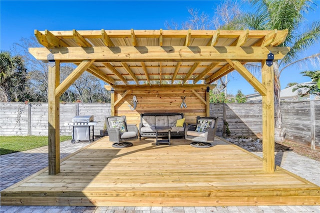 wooden terrace featuring area for grilling and an outdoor living space