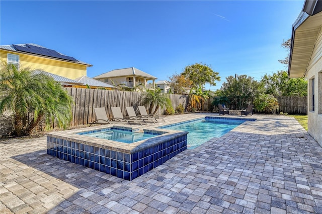 view of swimming pool with an in ground hot tub and a patio