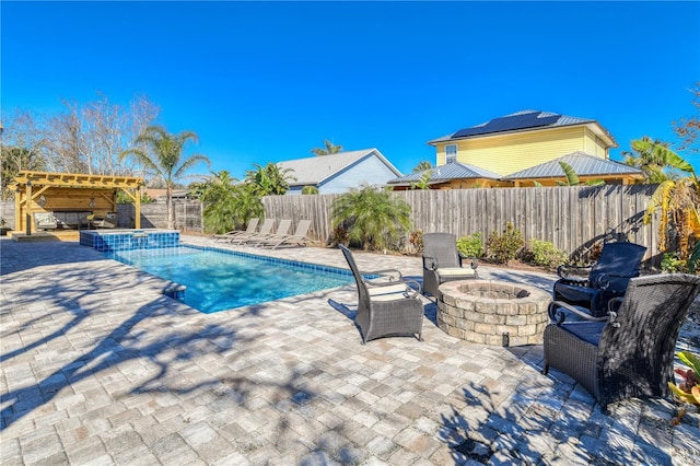 view of pool with a patio area, an in ground hot tub, and an outdoor fire pit