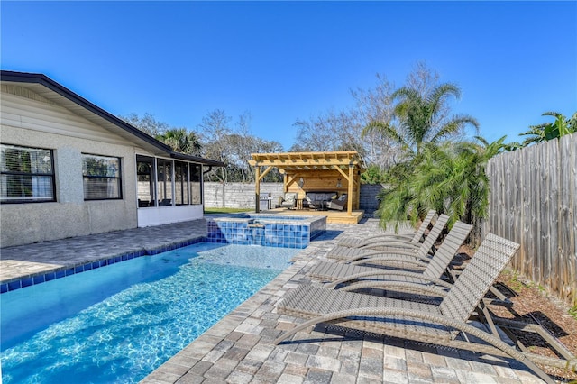 view of pool featuring a sunroom, an in ground hot tub, and a patio