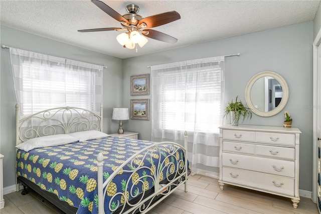 bedroom with a textured ceiling and ceiling fan