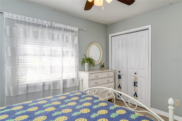 bedroom featuring hardwood / wood-style floors, ceiling fan, a textured ceiling, and a closet