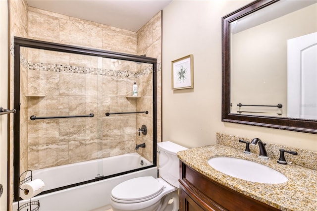 full bathroom with vanity, toilet, and shower / bath combination with glass door