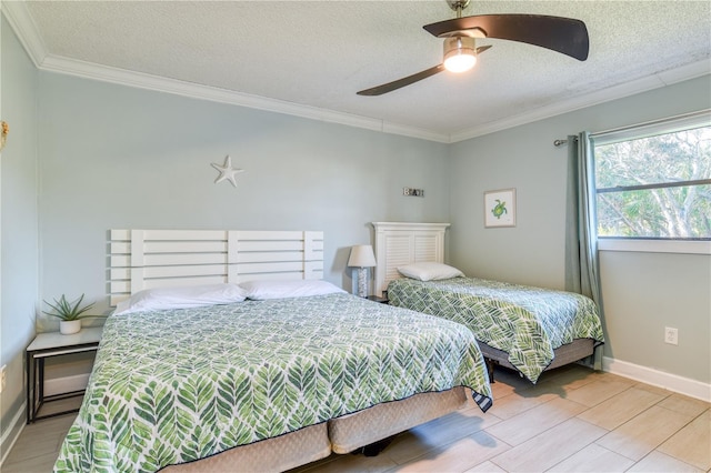 bedroom with a textured ceiling, ceiling fan, and ornamental molding